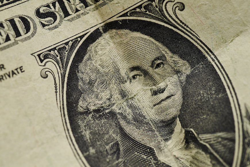 Close-up of George Washington on a worn US one-dollar bill