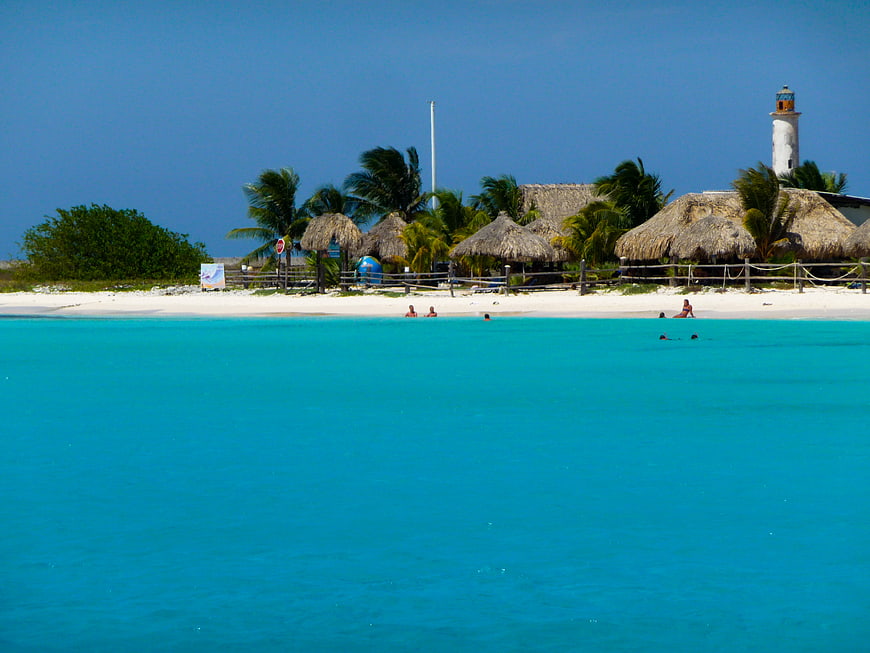 Tropical Beach Resort with Turquoise Water and Thatched Huts