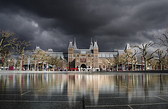 Rijksmuseum Amsterdam under dramatic storm clouds with reflection