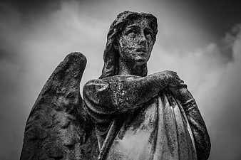 Black and White Stone Angel Statue Against Cloudy Sky