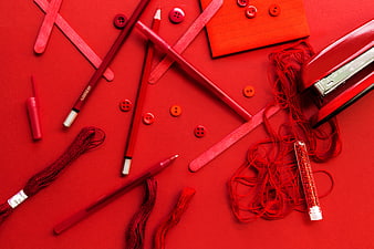 Red monochrome flat lay of craft supplies and stationery