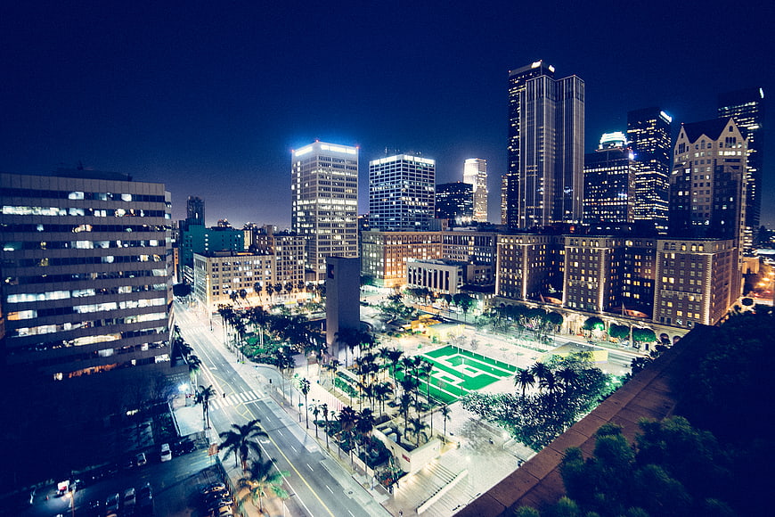 Nighttime aerial view of downtown Los Angeles skyline and Pershing Square