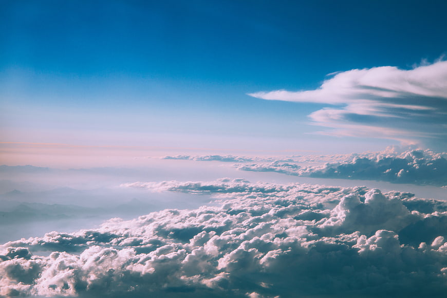 Aerial View of Fluffy Clouds Under Blue Sky
