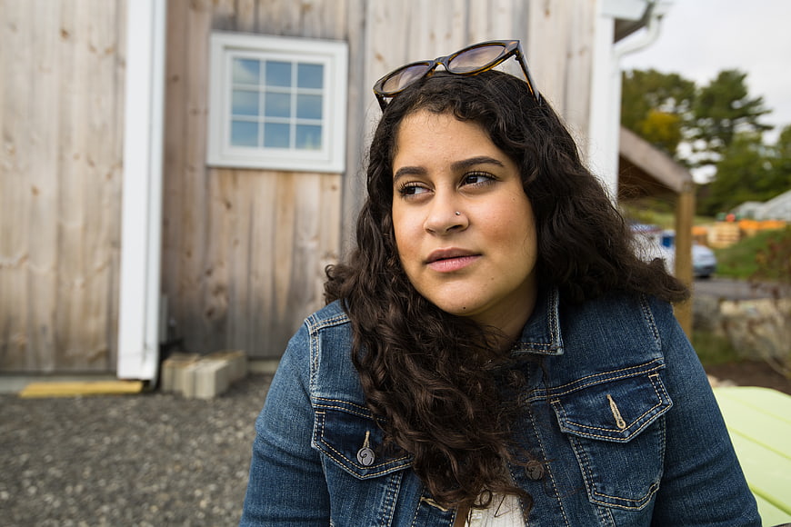 Portrait of young woman with curly hair outdoors