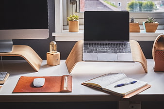 Minimalist wooden laptop stand on modern white desk
