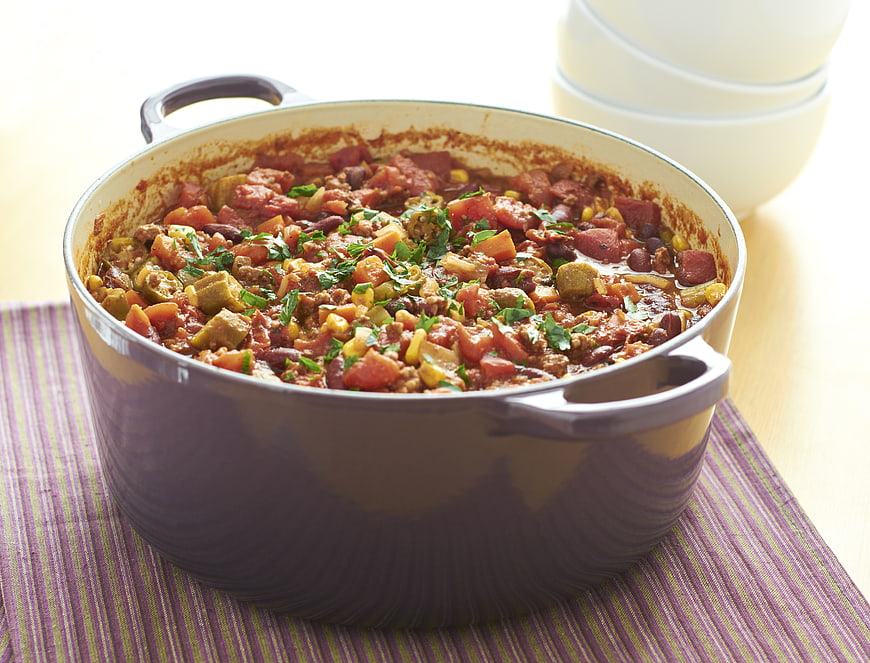 Hearty Beef Chili in Purple Dutch Oven with Fresh Herbs