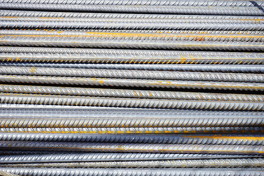 Stack of gray steel rebar rods with rust texture