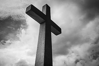 Low Angle Black and White Concrete Cross Against Cloudy Sky