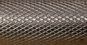 Close-up of silver metal mesh texture with diagonal pattern
