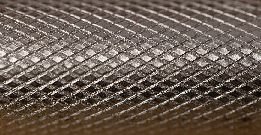Close-up of silver metal mesh texture with diagonal pattern
