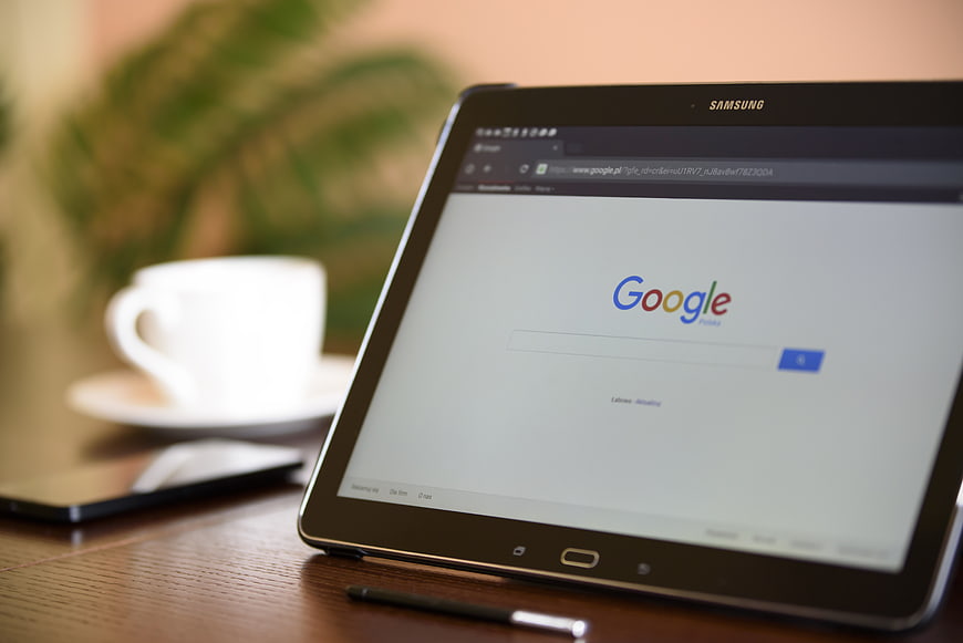 Samsung tablet displaying Google search on wooden desk