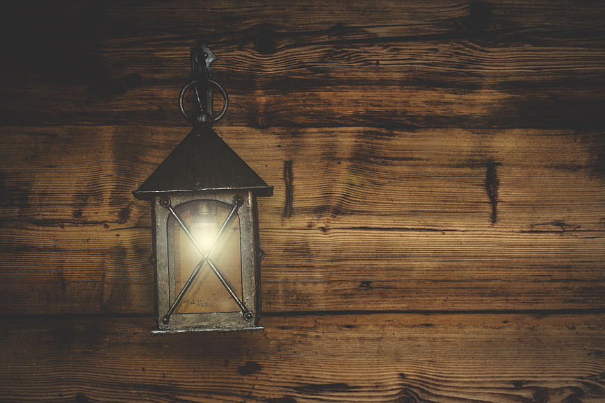 Vintage Lantern on Rustic Wooden Wall Background