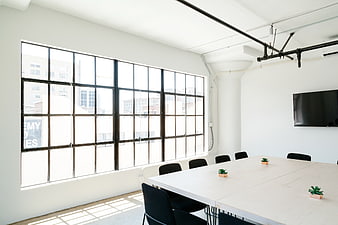 Modern minimalist office meeting room with large windows