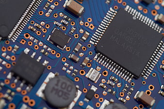 Macro shot of blue circuit board with microchips and electronic components