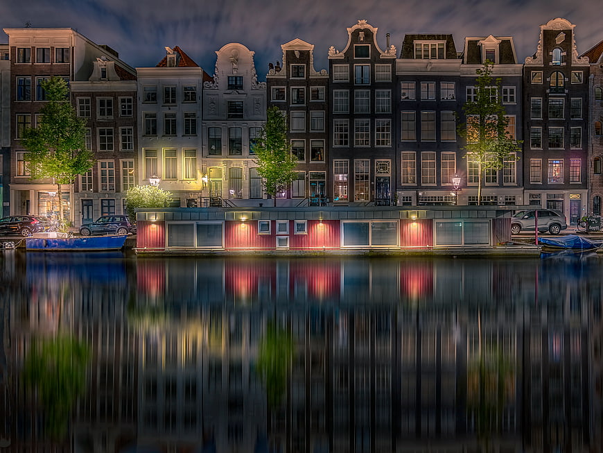 Night view of Amsterdam canal houses with reflections