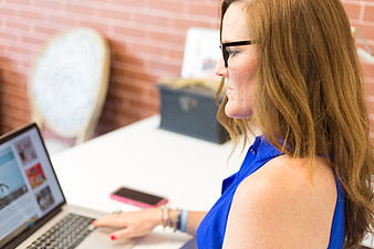 Professional woman working on laptop in modern office