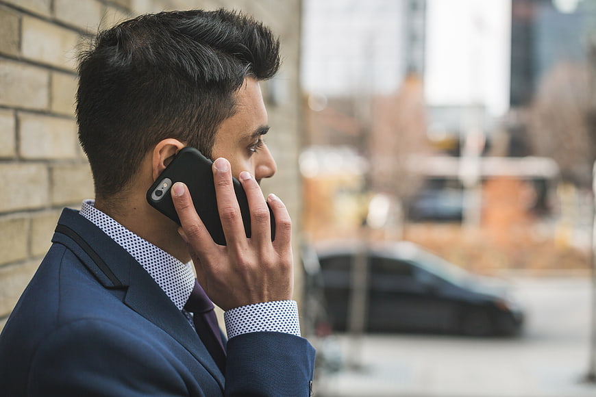 Businessman talking on smartphone outdoors