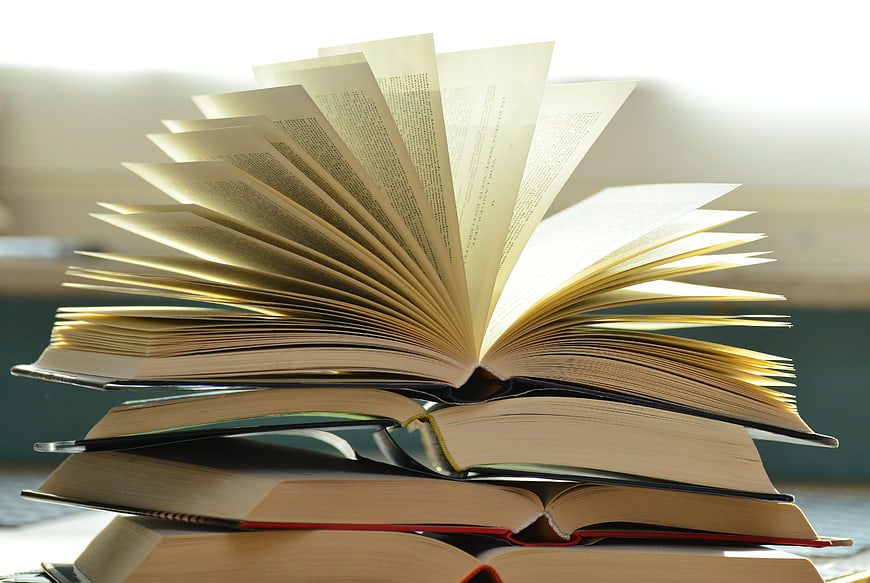 Stack of Open Books with Fanned Pages