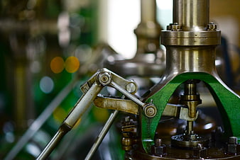 Close-up of vintage industrial machinery with brass and green metal parts