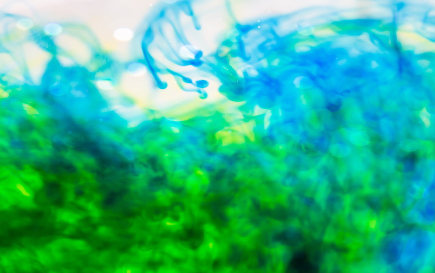 Abstract Blue and Green Ink Swirling in Water
