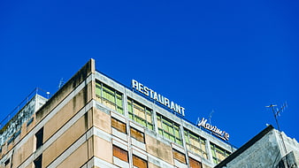Low angle view of restaurant building against blue sky