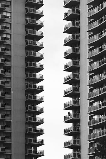 Black and white symmetrical view of modern apartment balconies