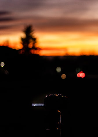 Camera Silhouette Capturing Vibrant Sunset Bokeh