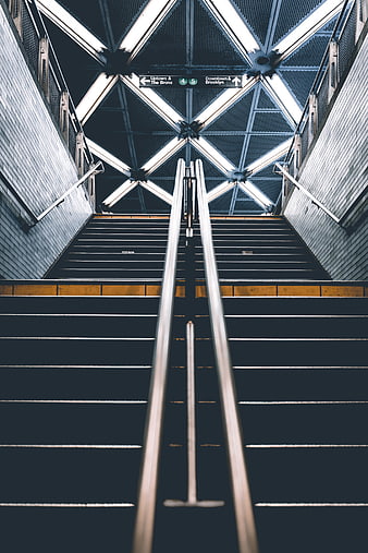 Symmetrical subway stairs leading to city exit
