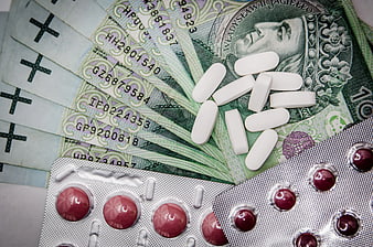White Pills and Blister Pack on Polish Zloty Banknotes