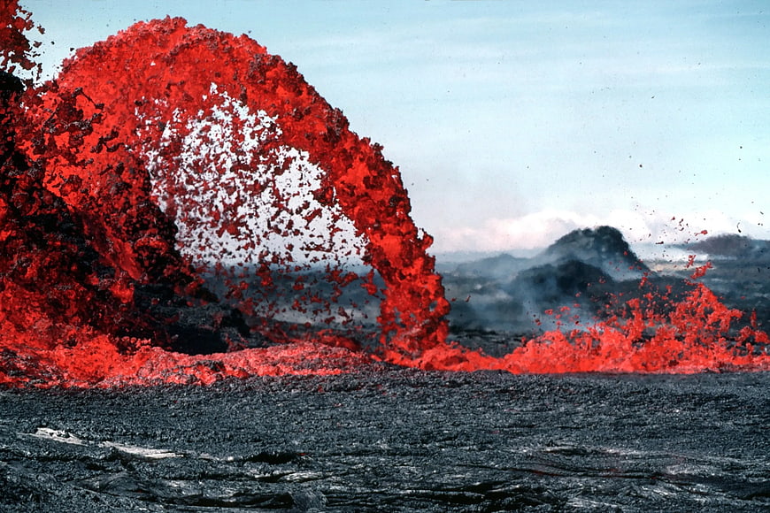 Dramatic volcanic eruption with glowing red lava fountain
