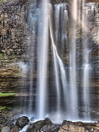 Long Exposure Waterfall Cascading Down Rocky Cliff Face