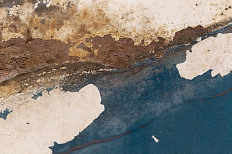 Close-up of peeling paint and rust on weathered metal surface