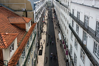 High angle view of Lisbon street with terracotta roofs and pedestrians