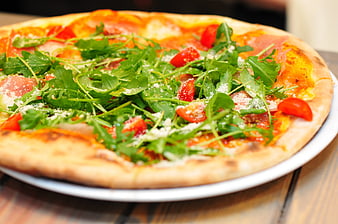 Fresh Arugula and Tomato Pizza on Wooden Table