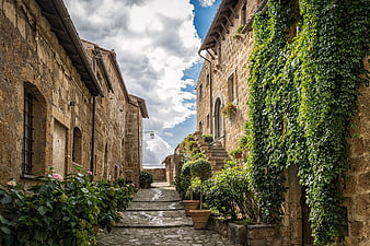 Narrow cobblestone street in historic European village with stone houses