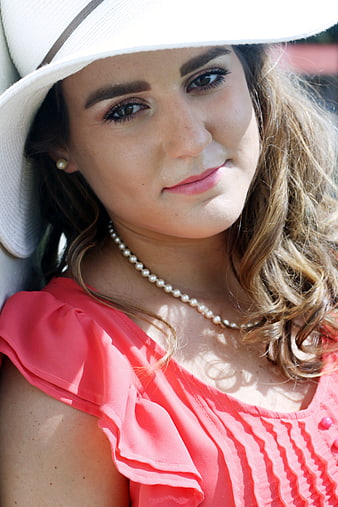 Stylish Woman in White Hat and Pink Top Portrait