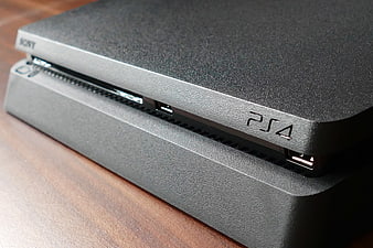 Close-up of Black PlayStation 4 Console on Wooden Surface