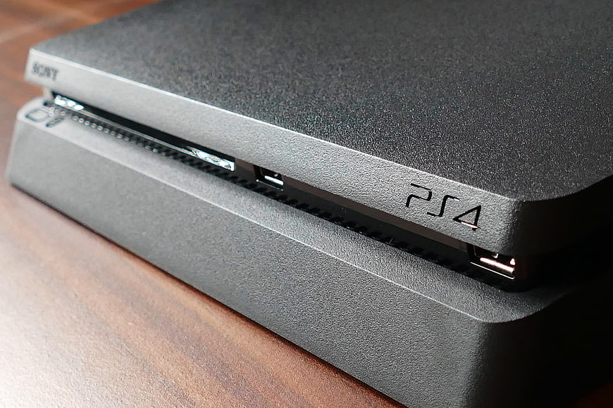 Close-up of Black PlayStation 4 Console on Wooden Surface