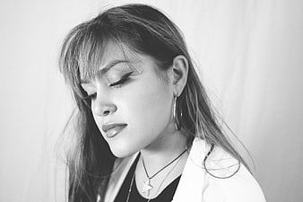 Black and white portrait of a woman with closed eyes and jewelry
