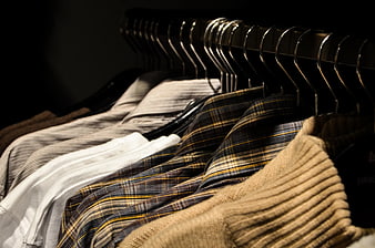 Assorted Men's Shirts and Sweaters on Hangers