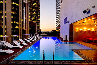 Modern Rooftop Pool at Dusk with City Skyline
