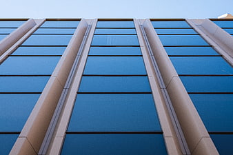Low angle view of modern glass office building facade