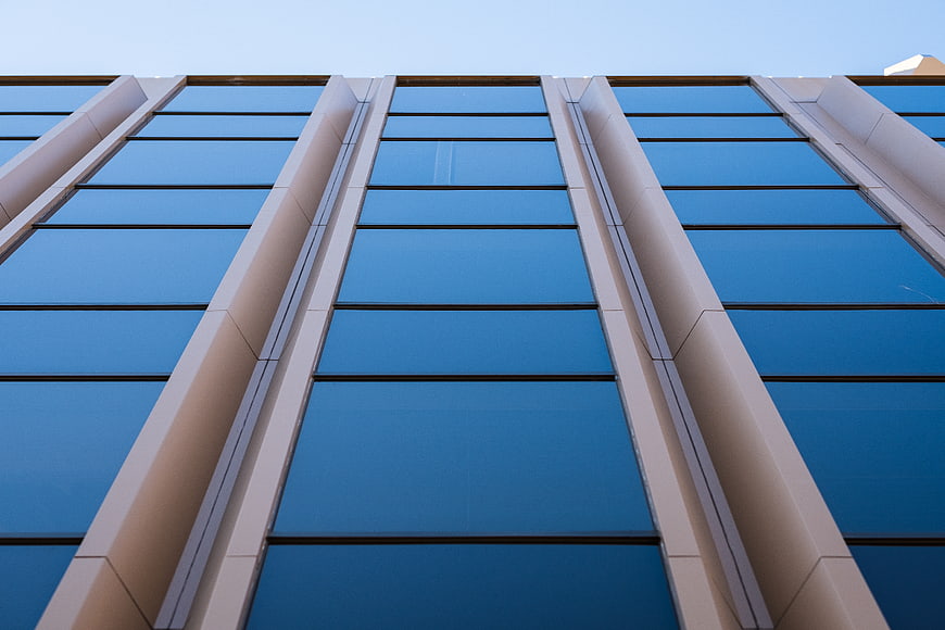 Low angle view of modern glass office building facade