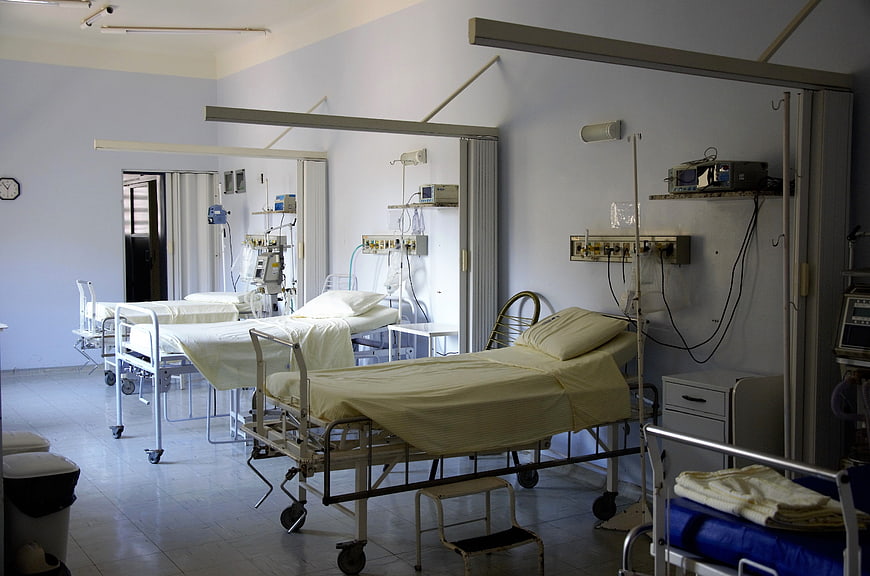 Empty hospital ward with beds and medical equipment