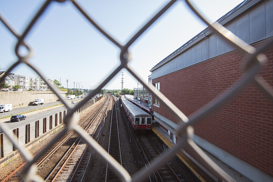 Train station view through chain link fence