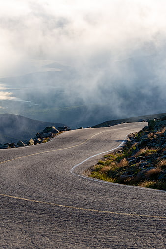 Winding Mountain Road Through Misty Clouds at Dawn