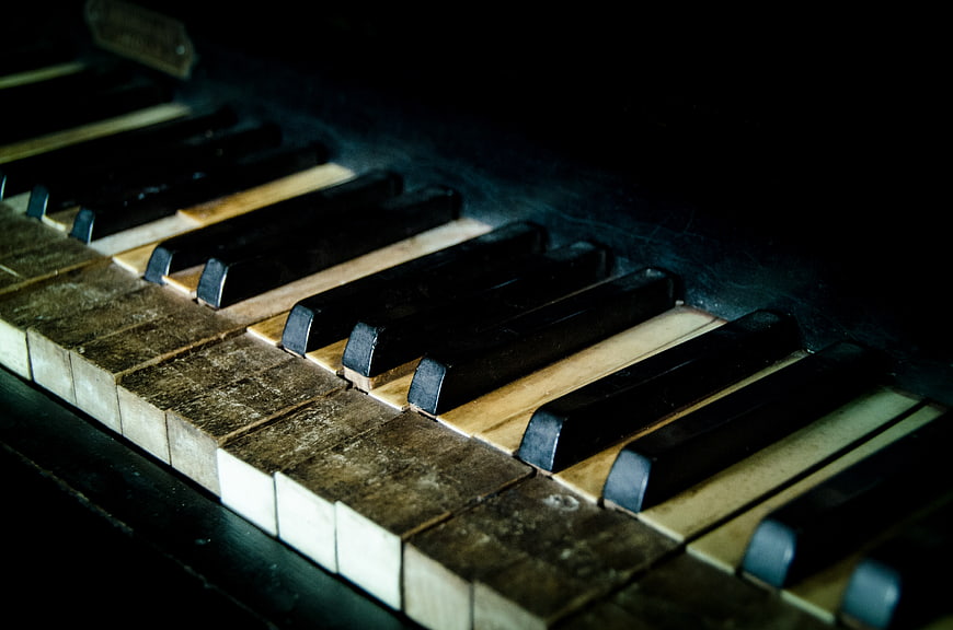 Close-up of vintage piano keys with worn ivory texture
