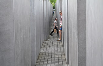 Tourists walking through the concrete slabs of the Holocaust Memorial