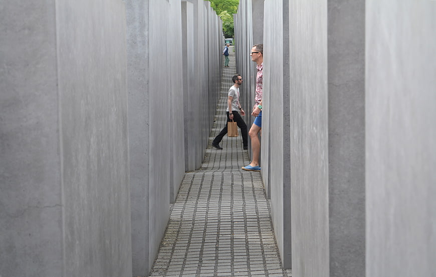 Tourists walking through the concrete slabs of the Holocaust Memorial