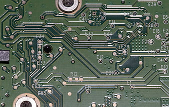 Close-up of green printed circuit board with copper traces